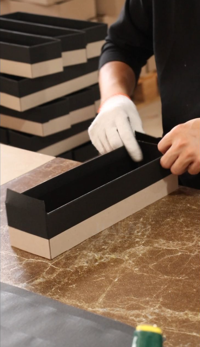 Careful hand assembly of a custom rigid box