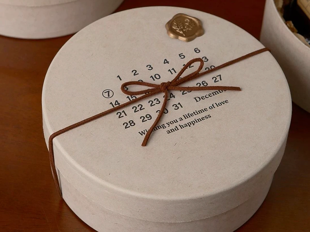 Round Calendar-Print Gift Box with Wax Seal and Cord Tie
